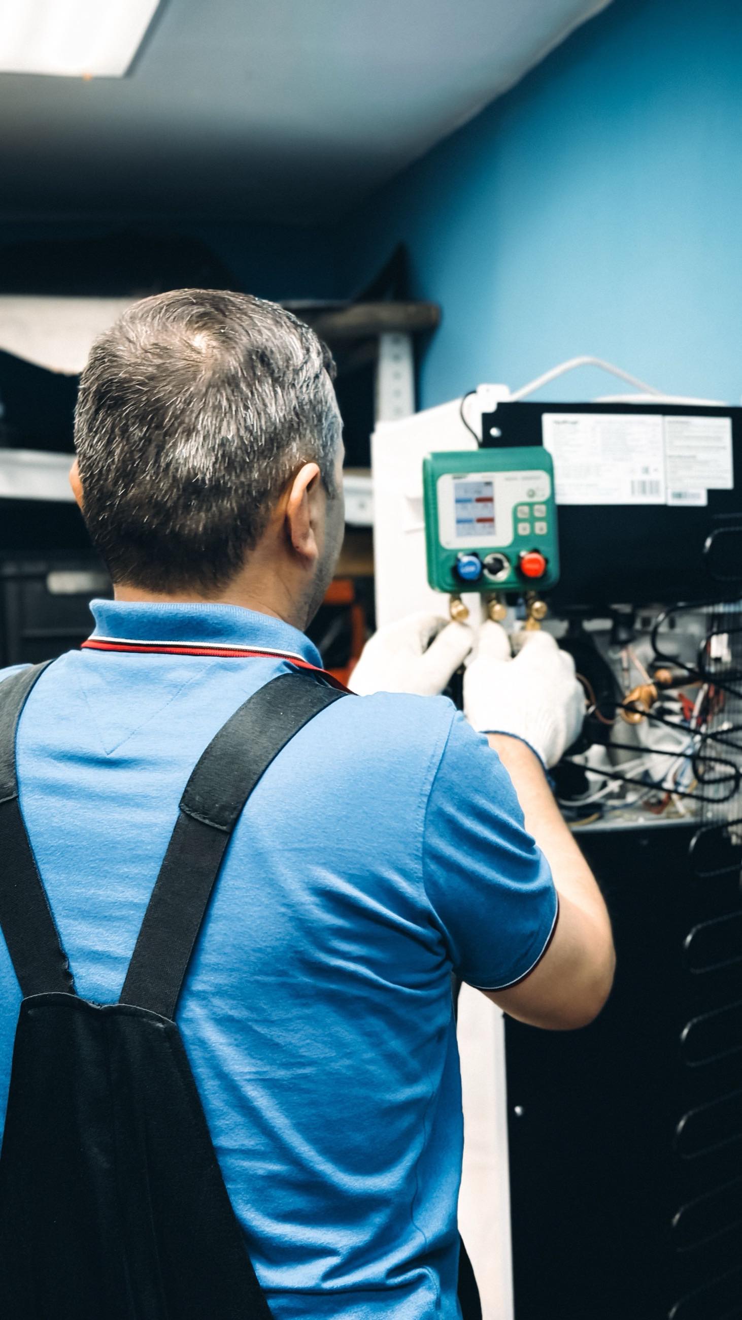 A technician testing an indoor control panel